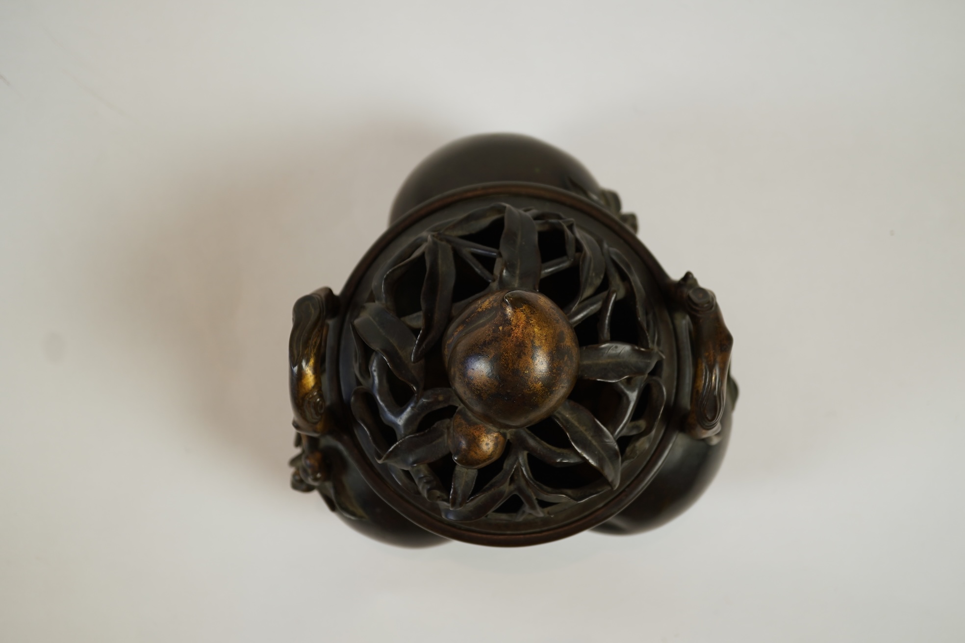 A large Chinese bronze and parcel gilt ‘peach’ censer and cover, Li, 17th/18th century